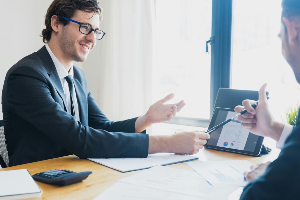 Young sales professional speaking confidently during a client meeting